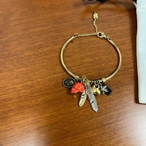 Coach Skull Coral colored 7 charm bracelet